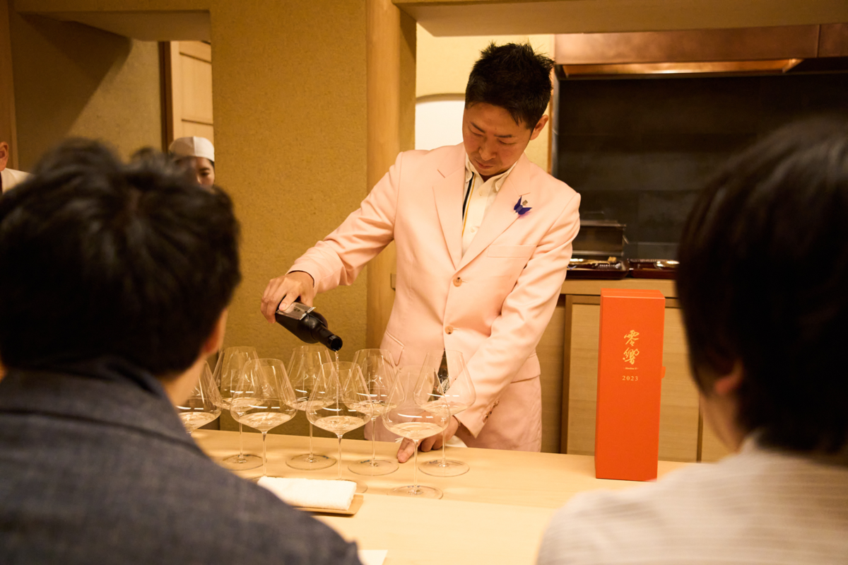 日本酒をグラスに注ぐ男性