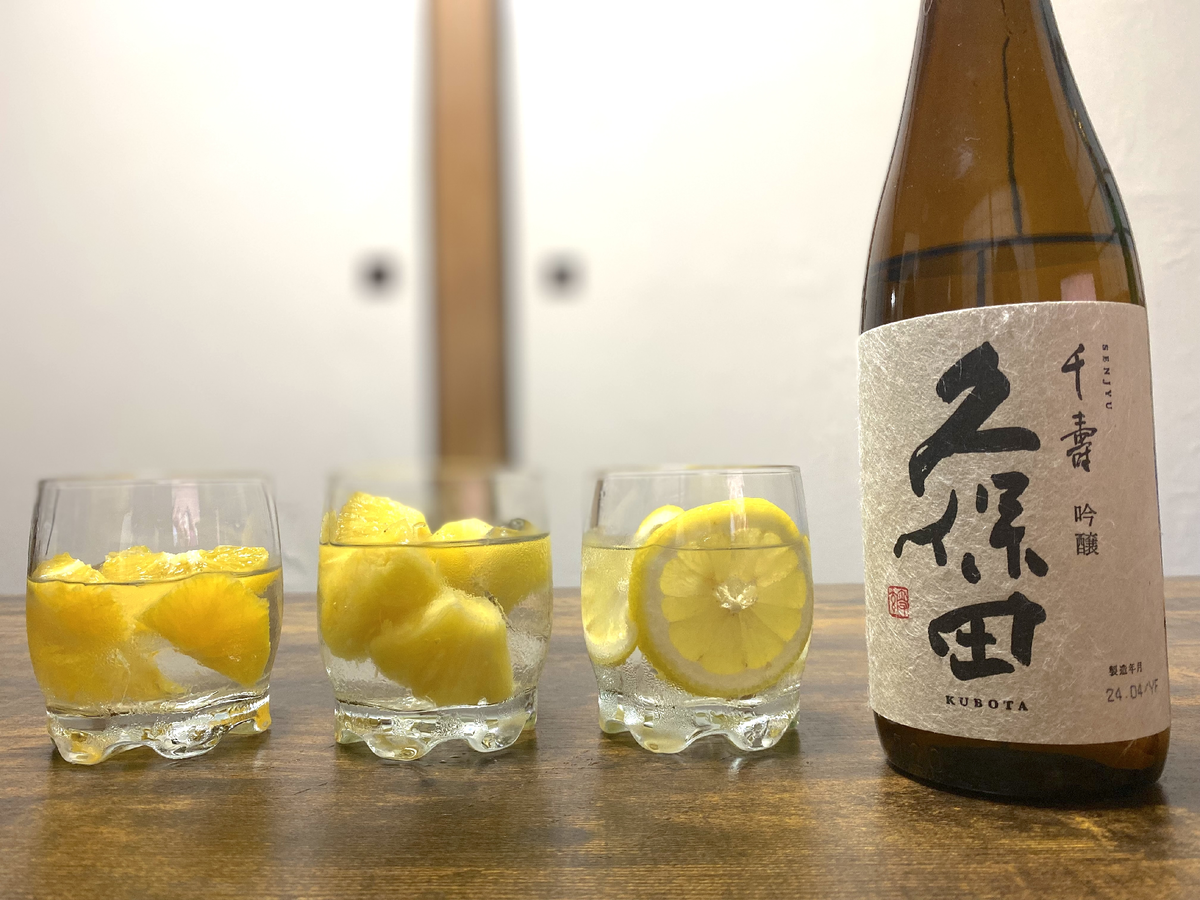 フルーツと日本酒が入ったグラス3つと日本酒の瓶