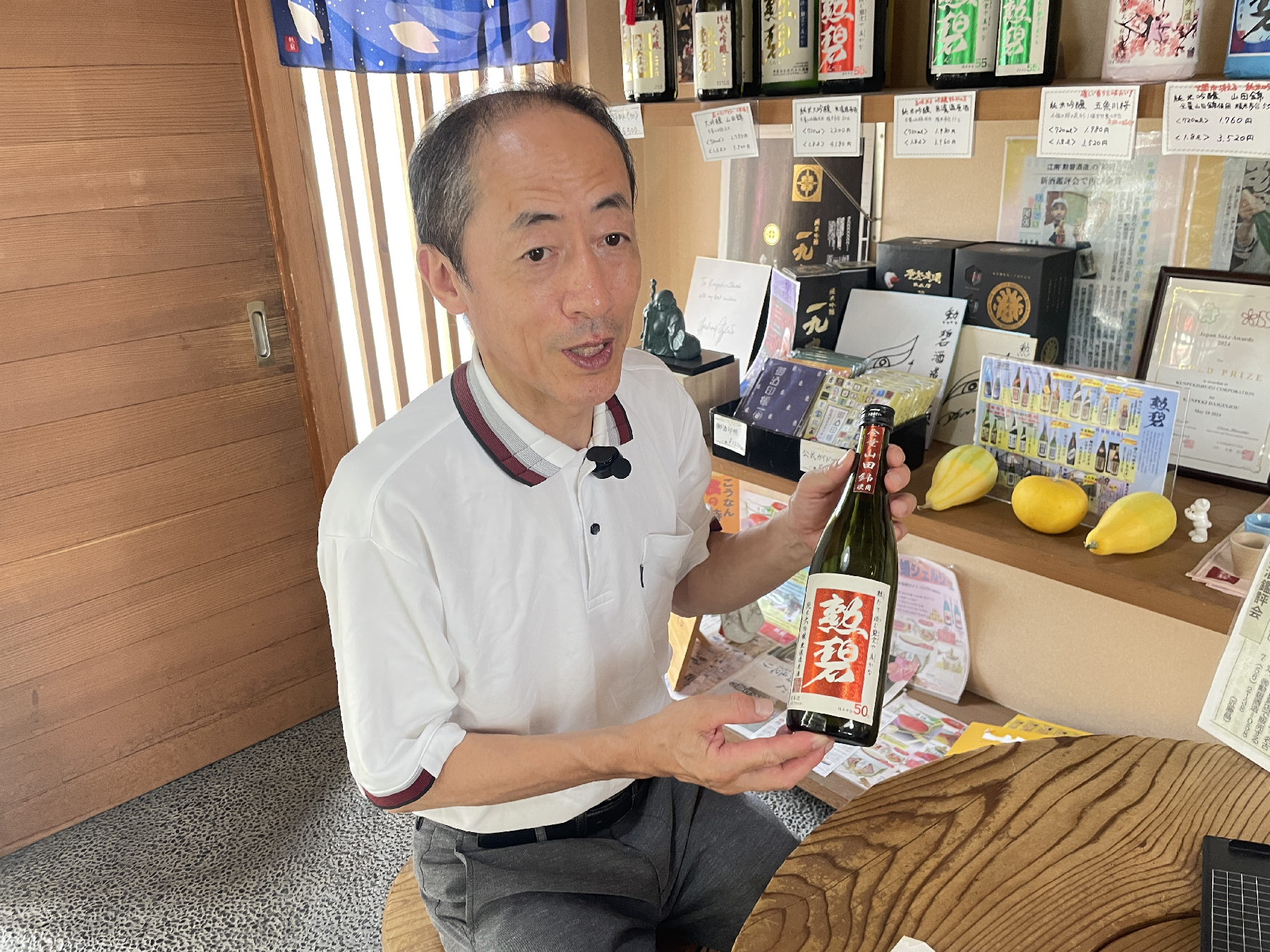 日本酒を手に持って話をする男性