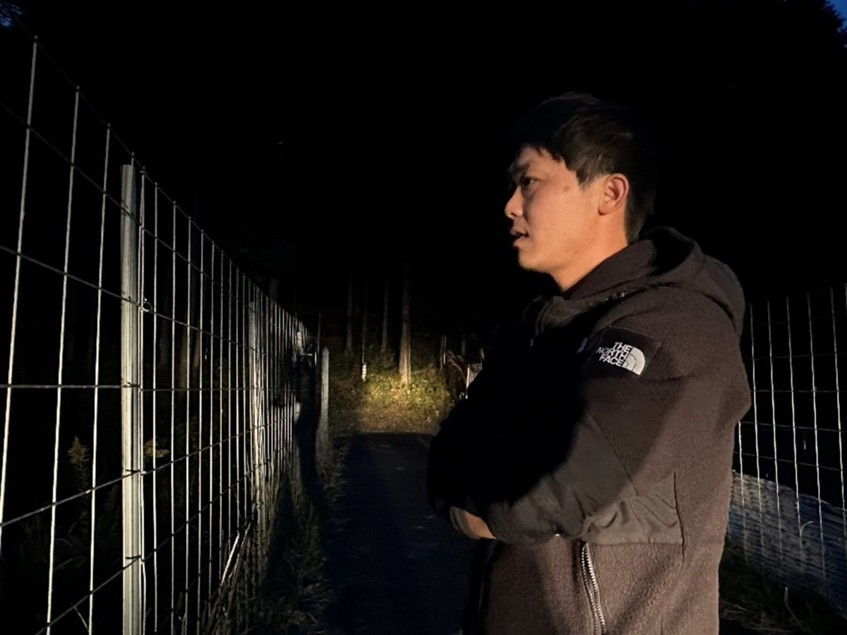 田を案内する男性