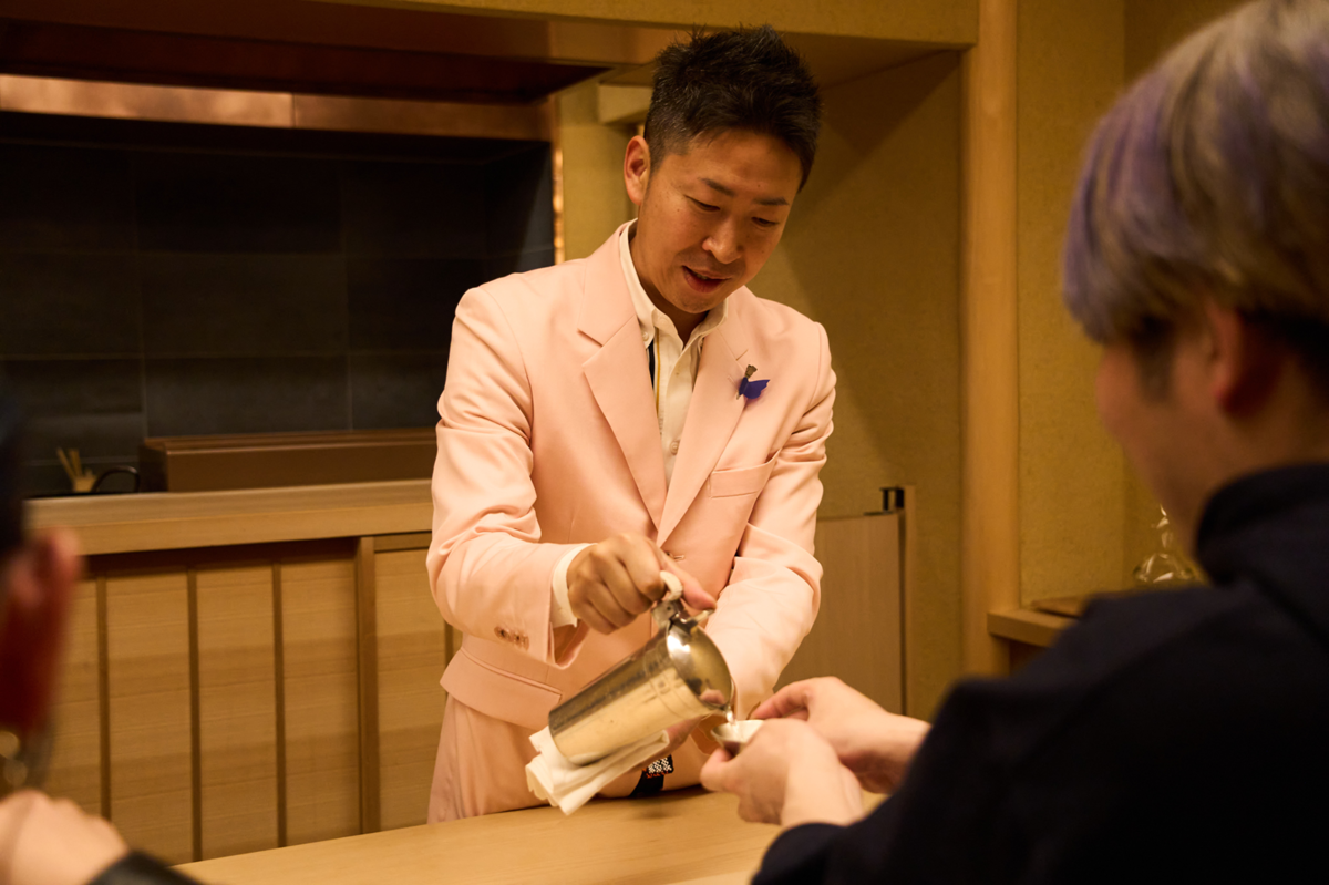 おちょこに日本酒を注ぐ男性