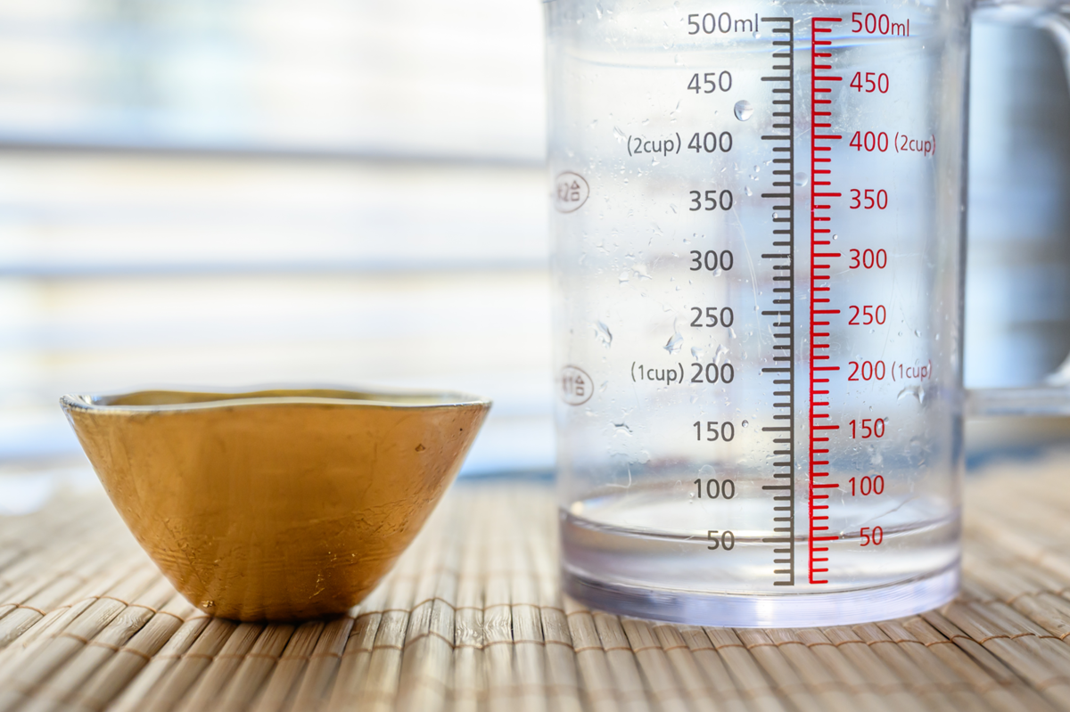 平たいおちょこに入る日本酒の量を計量する様子