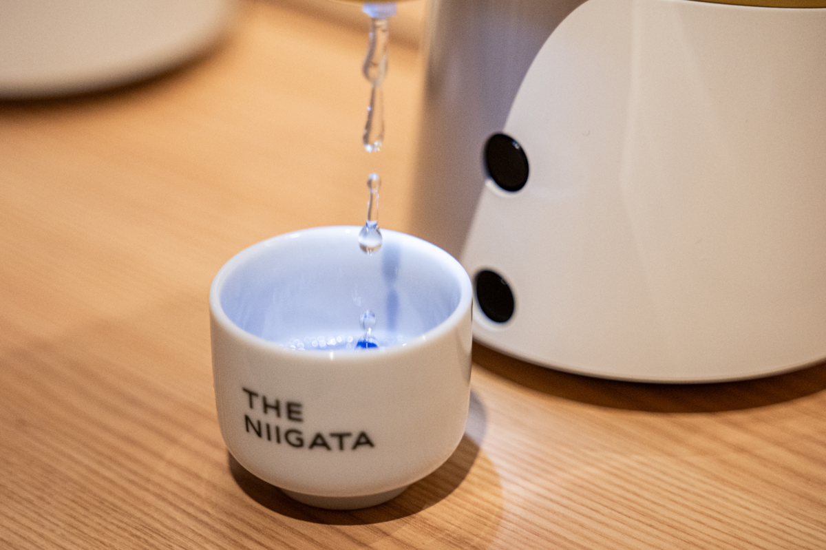 「のまっせ」からおちょこに注がれる日本酒